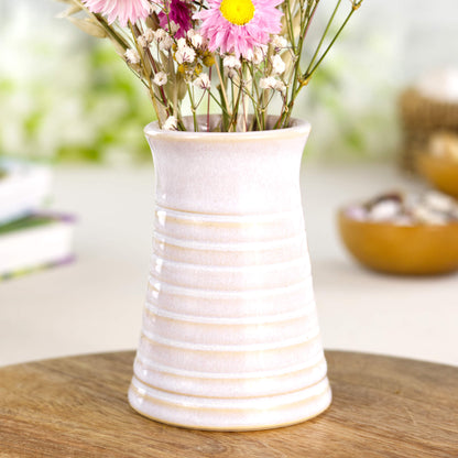 Handmade white ribbed ceramic bud vase displayed on a wooden board, perfect for Scandinavian-inspired interiors.
