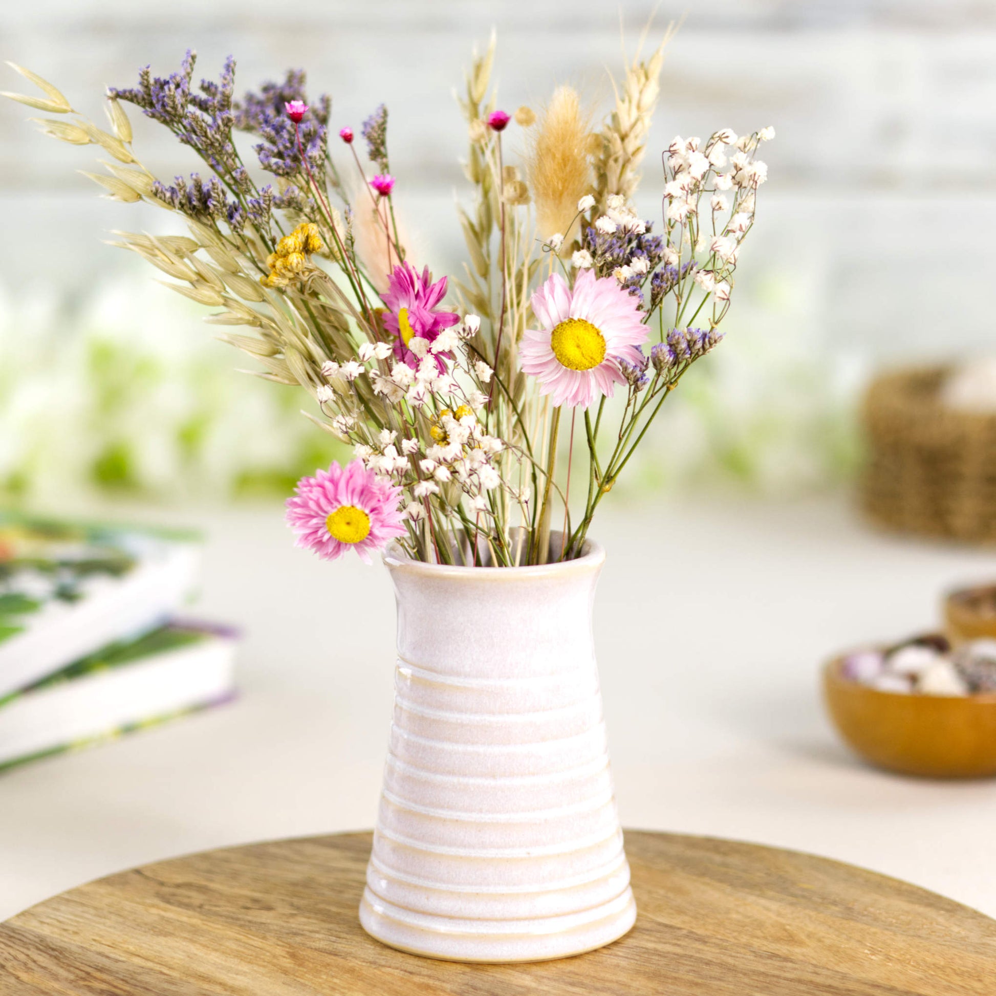 White ribbed ceramic bud vase styled with colourful dried flowers, blending modern simplicity with cottagecore charm.