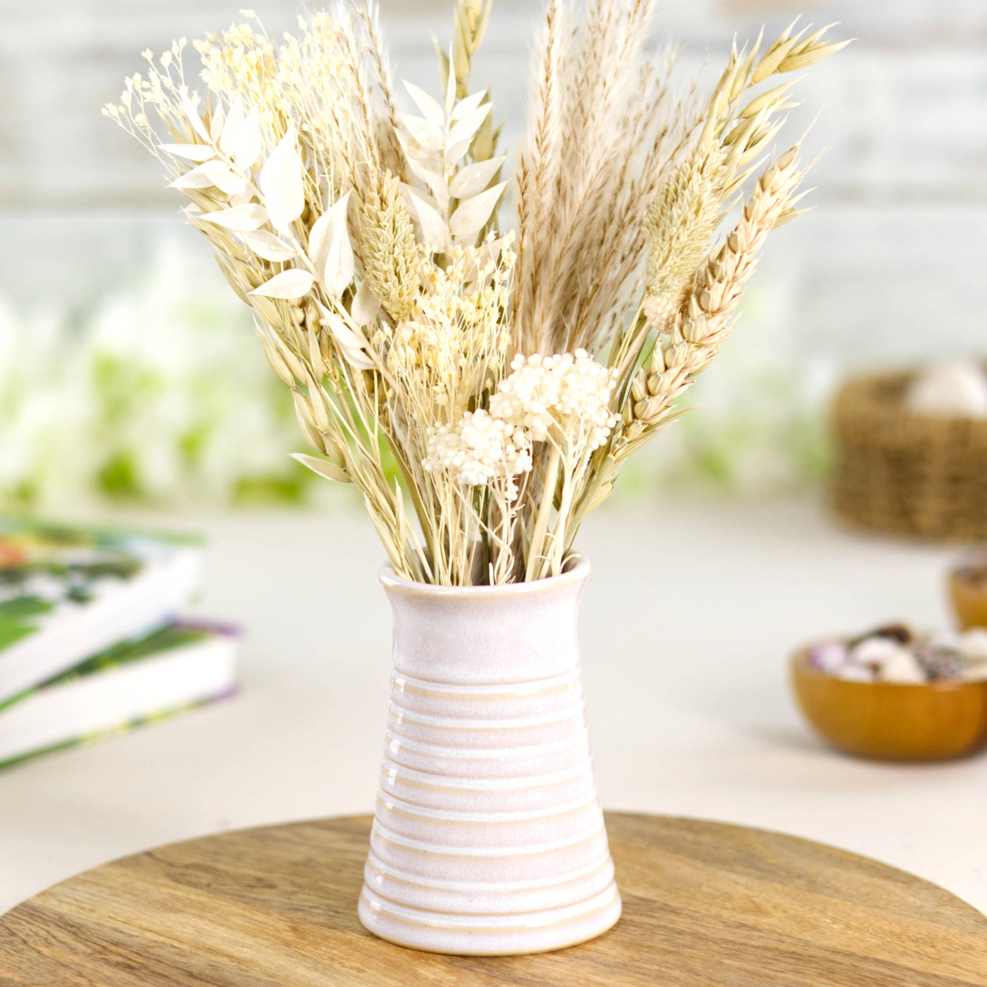 White ribbed ceramic bud vase arranged with natural dried grasses, embodying a calm Scandinavian and wabi-sabi aesthetic.