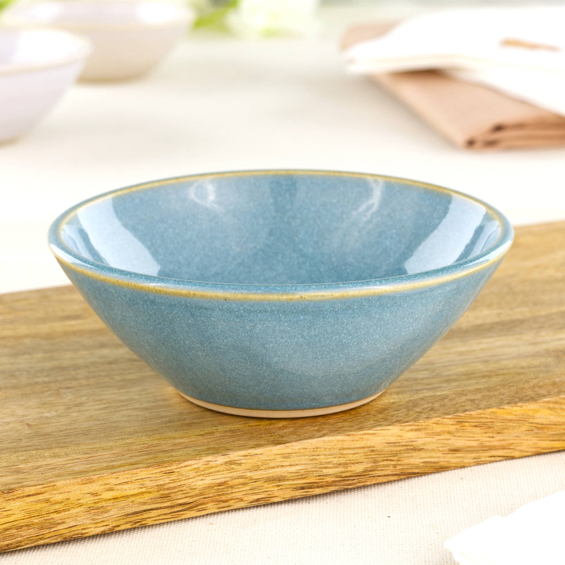 Coastal Blue ceramic small bowl on wooden board, a handmade stoneware dip bowl for sauces, snacks and everyday table moments