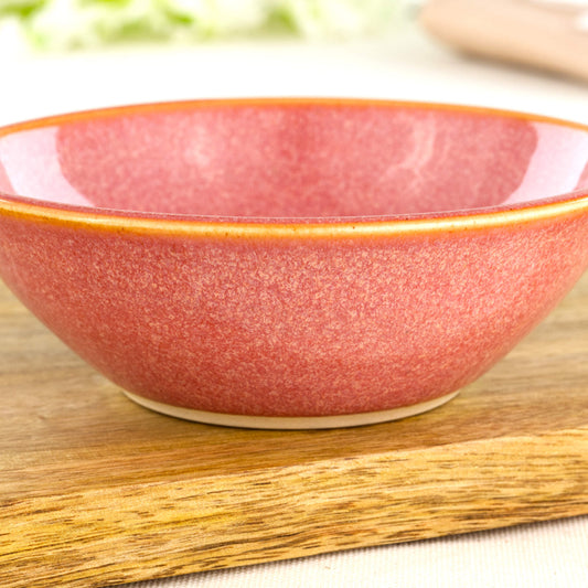 Close-up of warm Coral Sea Smoothed Pebble glaze on a wheel-thrown snack bowl with glossy speckled surface