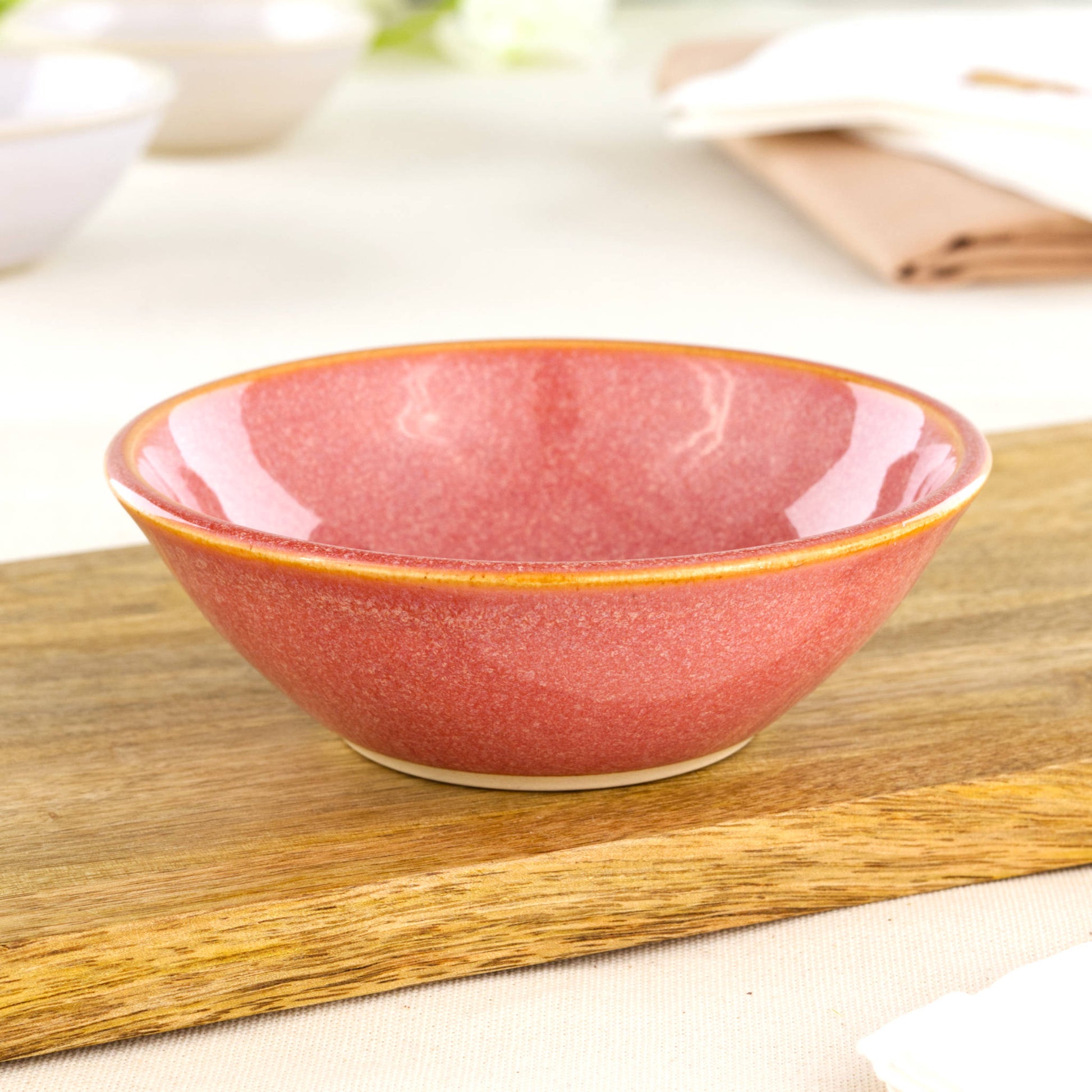 Coral small pottery bowl on wooden board, ideal for tapas, nuts, sweets, desserts and colourful garden party table styling