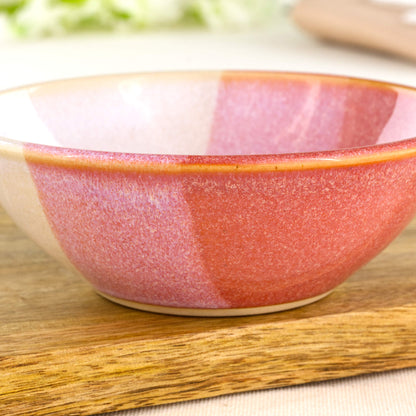 Close-up of Coral and White double-dipped Sea Smoothed Pebble glaze on a wheel-thrown stoneware bowl, showing the soft two-tone finish and handmade texture