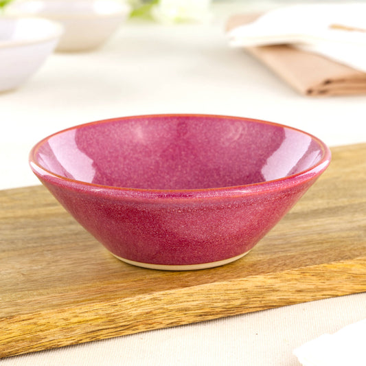 Crimson ceramic snack bowl on wooden board, a handmade pottery bowl for nuts, olives, tapas and cosy sharing food