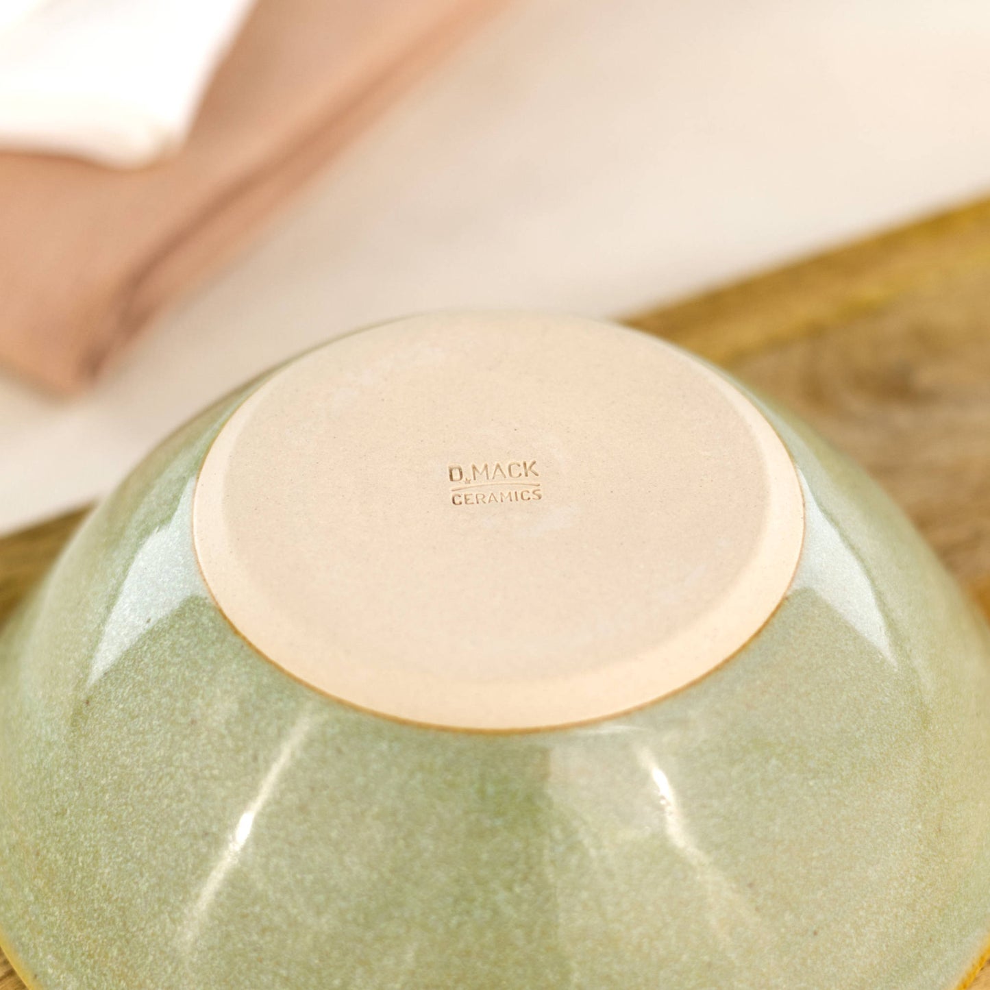 Base of Pale Green handmade small bowl showing smooth burnished clay and maker’s mark from my Sussex studio