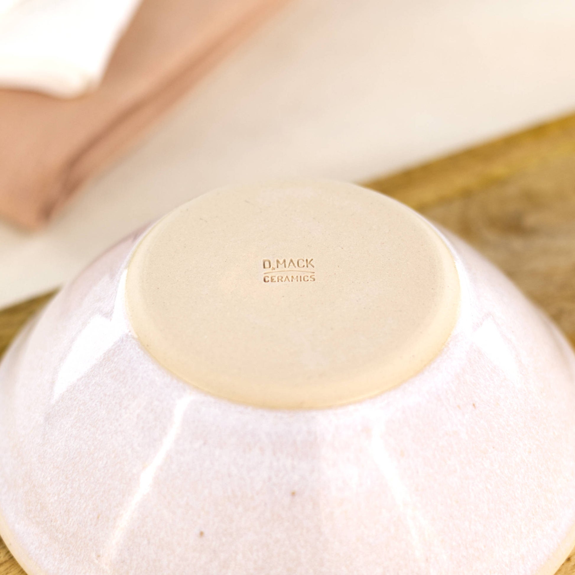Base of White handmade small bowl showing smooth burnished clay and maker’s mark from my Sussex pottery studio