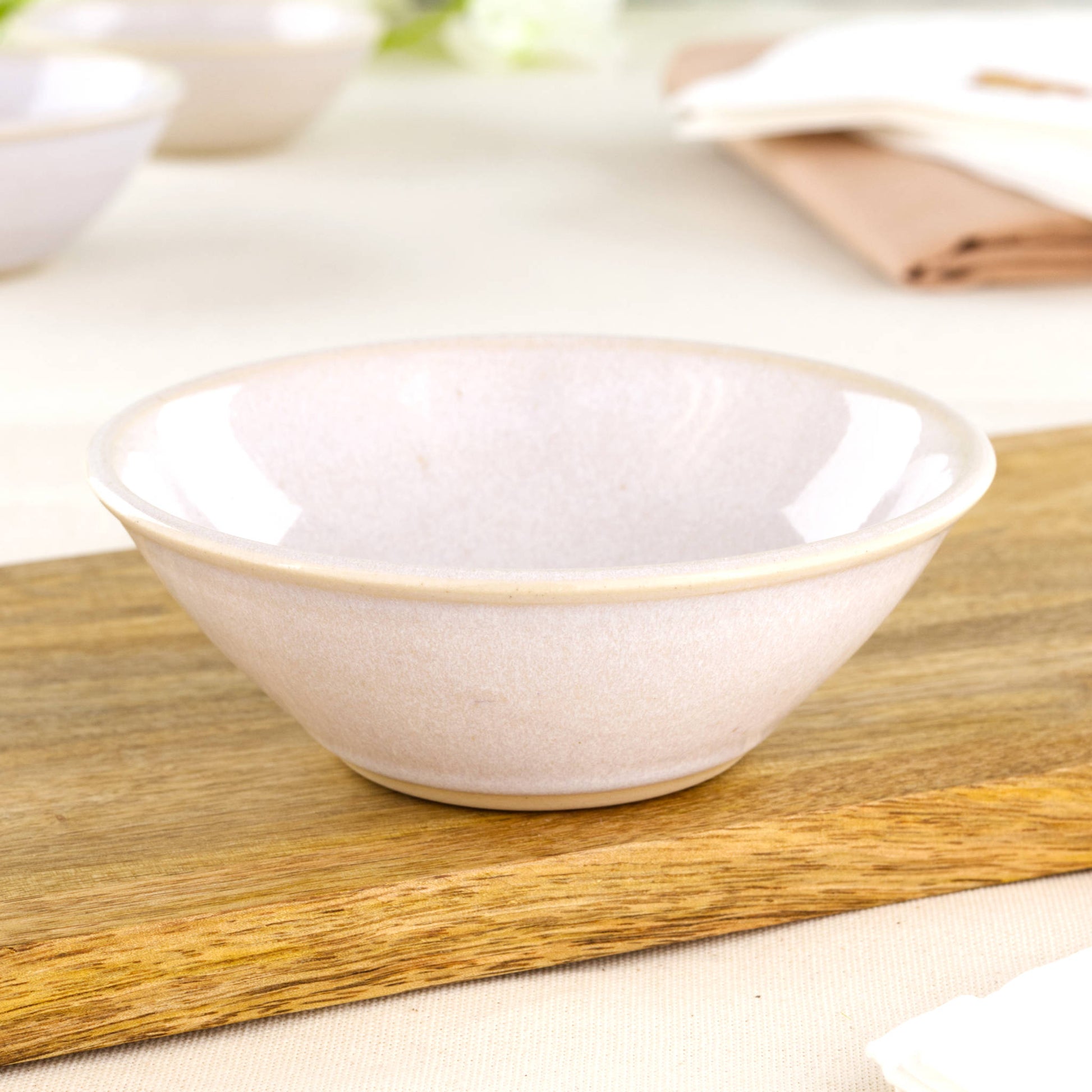 White stoneware snack bowl on wooden board, a handmade pottery bowl for tapas, sweets, berries and farmhouse table moments