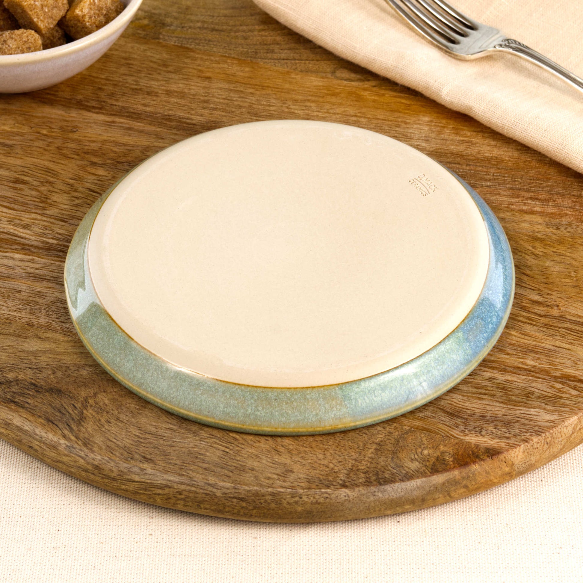 Base of a handmade Coastal Blue & Pale Green small plate, showing the smooth burnished foot and makers mark, wheel-thrown in my Sussex pottery studio
