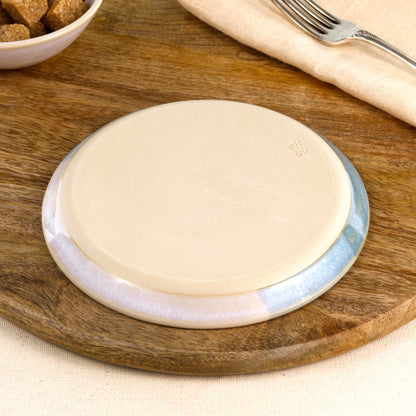 Base of a handmade Coastal Blue and White small plate, showing the smooth burnished foot and makers mark, wheel-thrown in a Sussex pottery studio