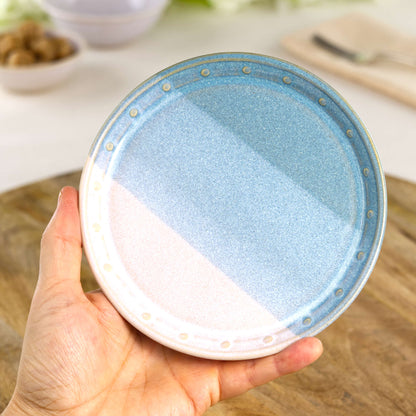 Handmade Coastal Blue and White small plate held in the hand, a wheel-thrown stoneware side plate from a British artisan studio