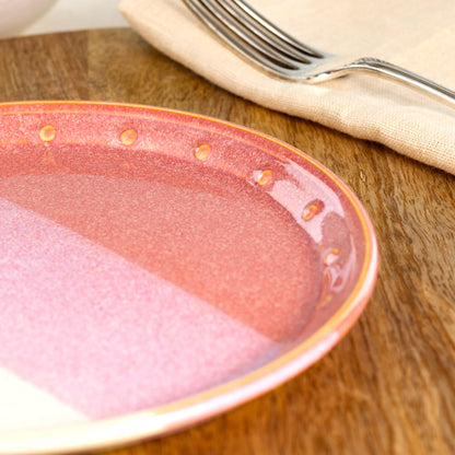 Close-up of a Coral & White ceramic small plate, highlighting the glossy speckled glaze, hand-finished dotted rim and warm coral tones

