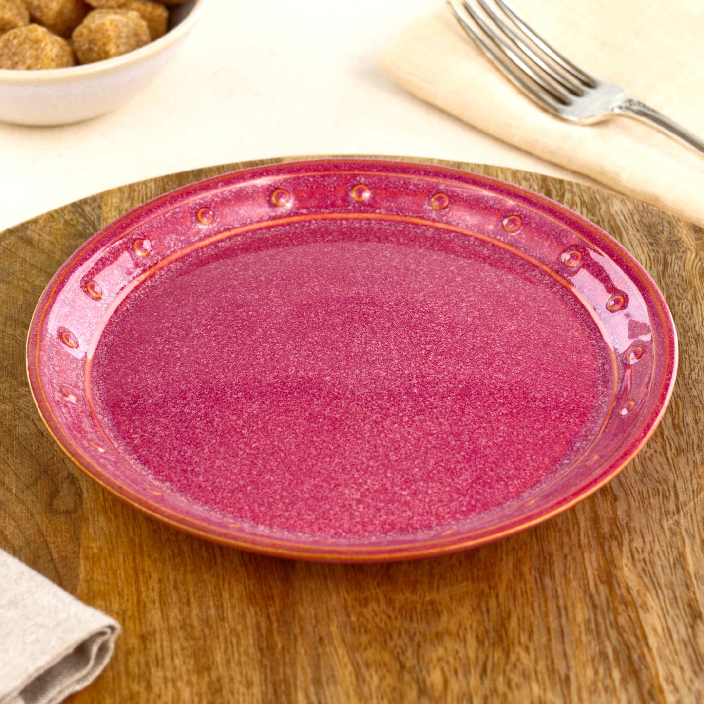 Crimson small plate on a wooden board, a handmade ceramic side plate for cake, pastries, snacks, starters or colourful everyday tableware