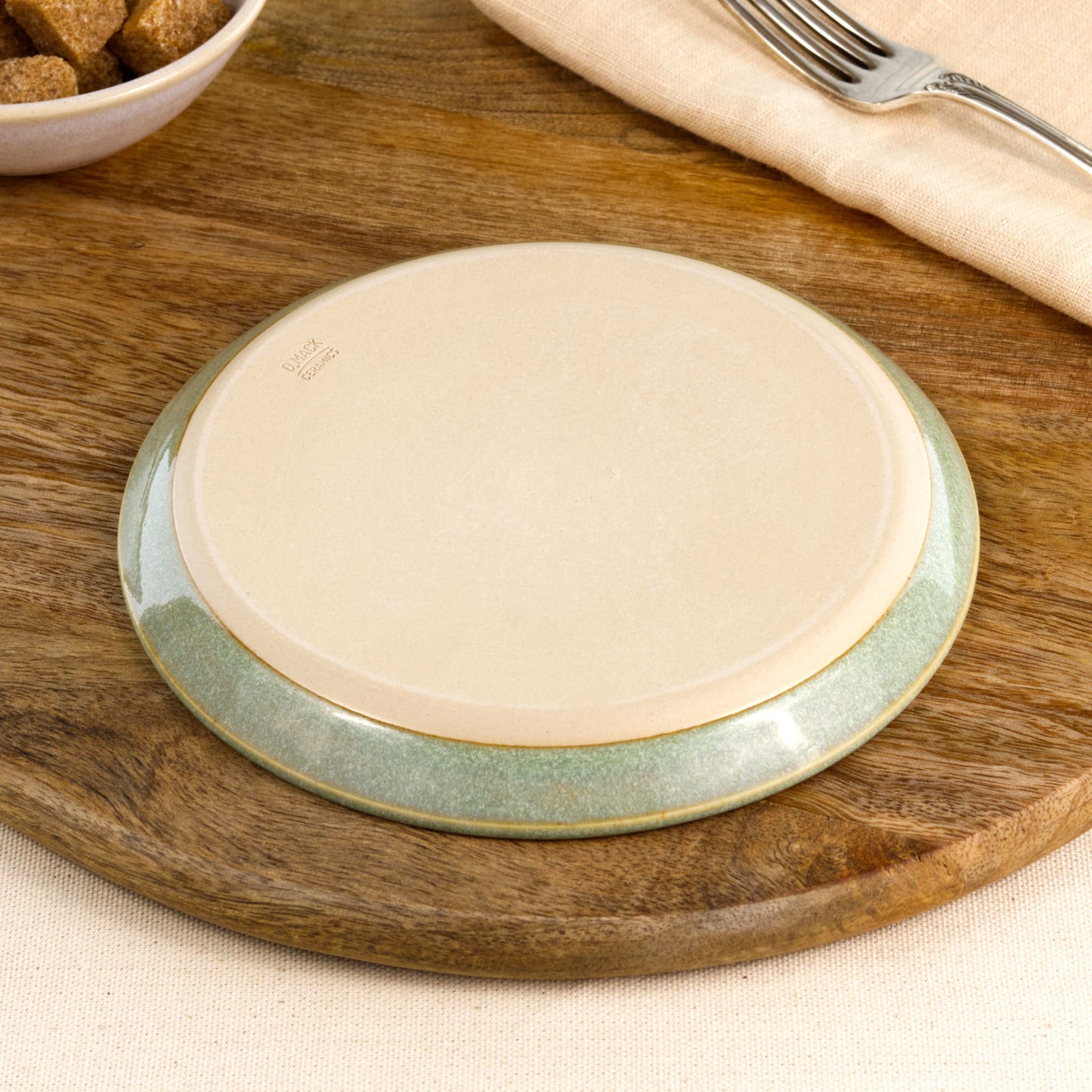 Base of a handmade Pale Green small plate, showing the smooth burnished foot and makers mark, wheel-thrown in my Sussex pottery studio