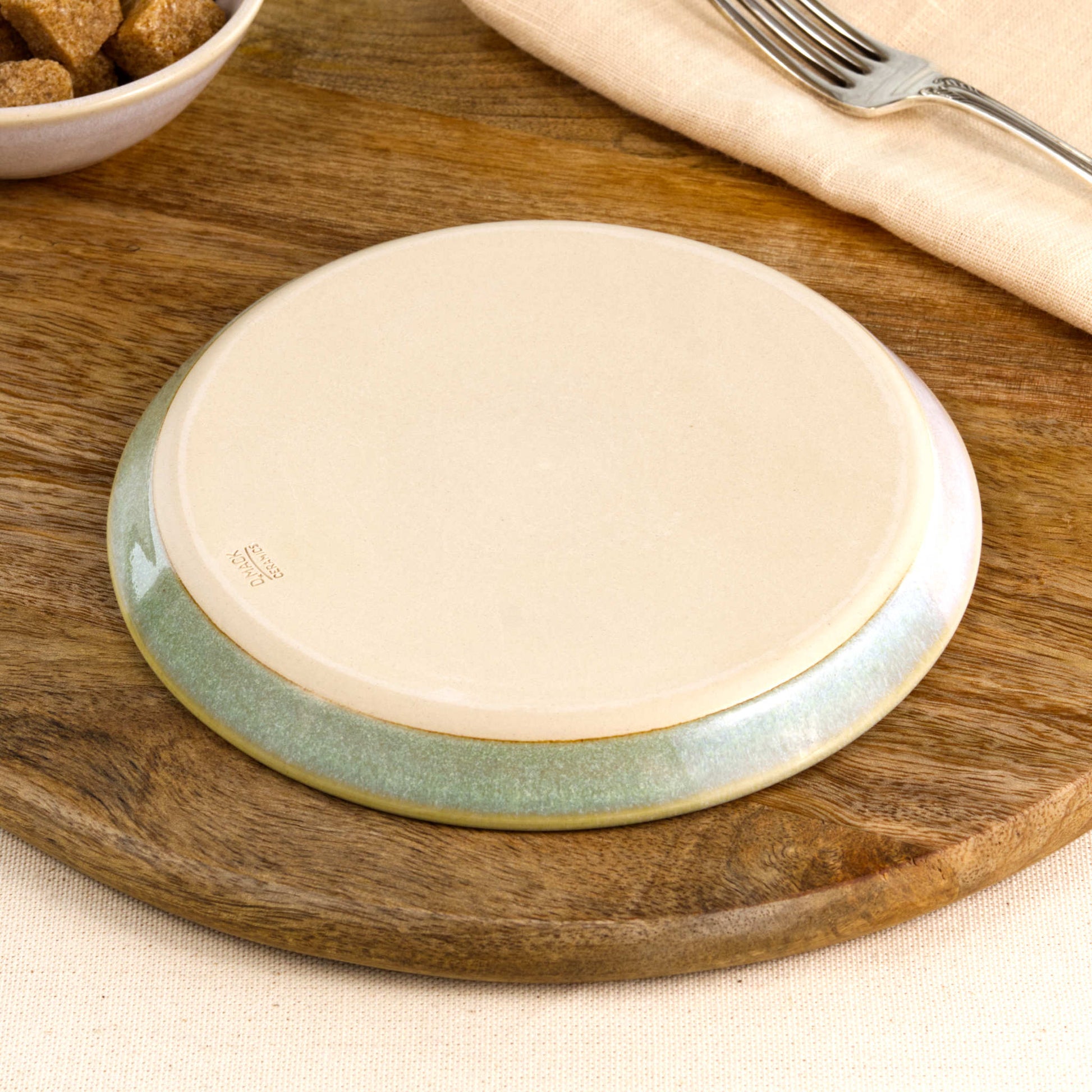Base of a handmade Pale Green & White small plate, showing the smooth burnished foot and makers mark, wheel-thrown in a small Sussex pottery studio