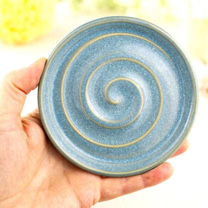 Coastal Blue pottery soap holder shown in hand, compact handmade soap tray with glossy speckled glaze and spiral ridges