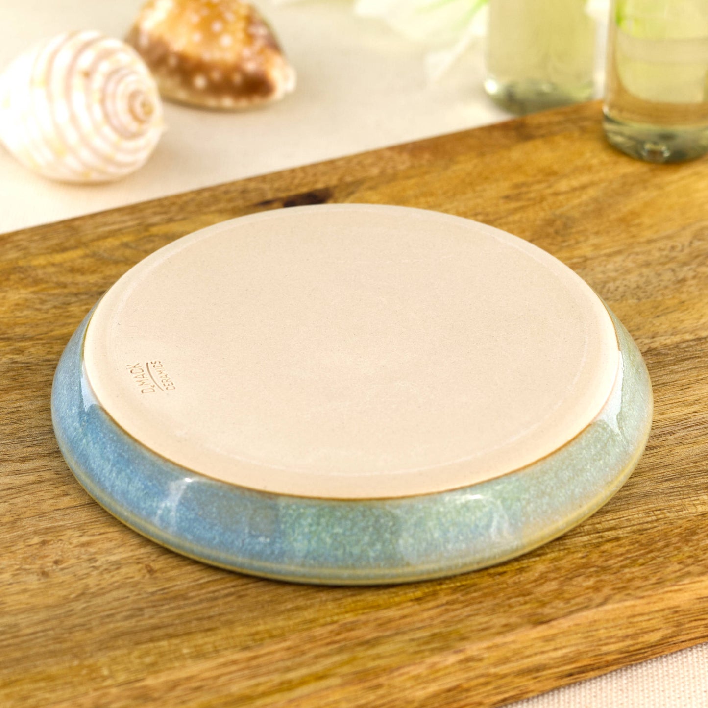 Underside of Coastal Blue and Pale Green soap dish with makers mark, burnished smooth base from Sussex artisan pottery studio