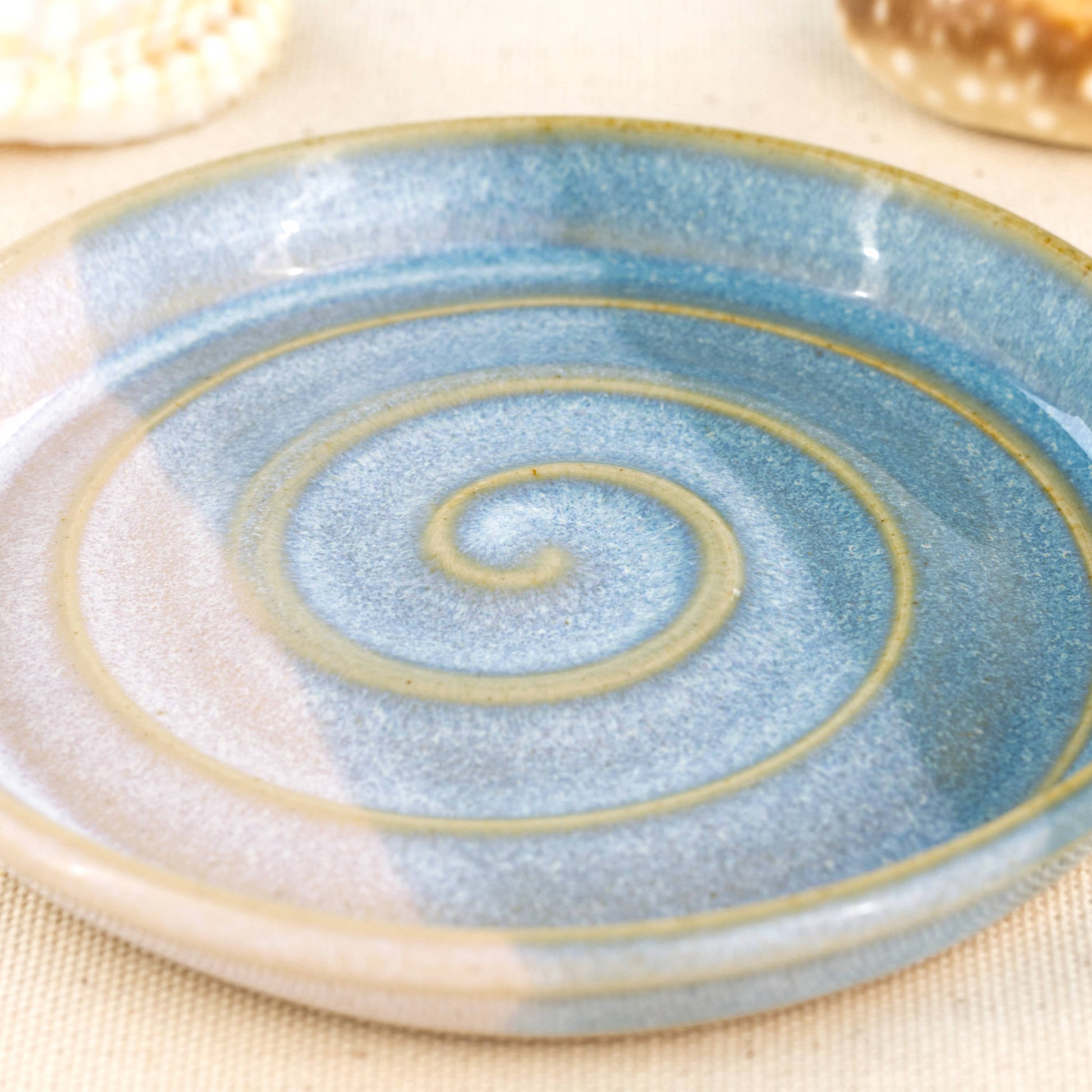 Close-up of Coastal Blue and White soap dish with my signature Sea Smoothed Pebble glaze, banded double dipped ceramic with layered glazes