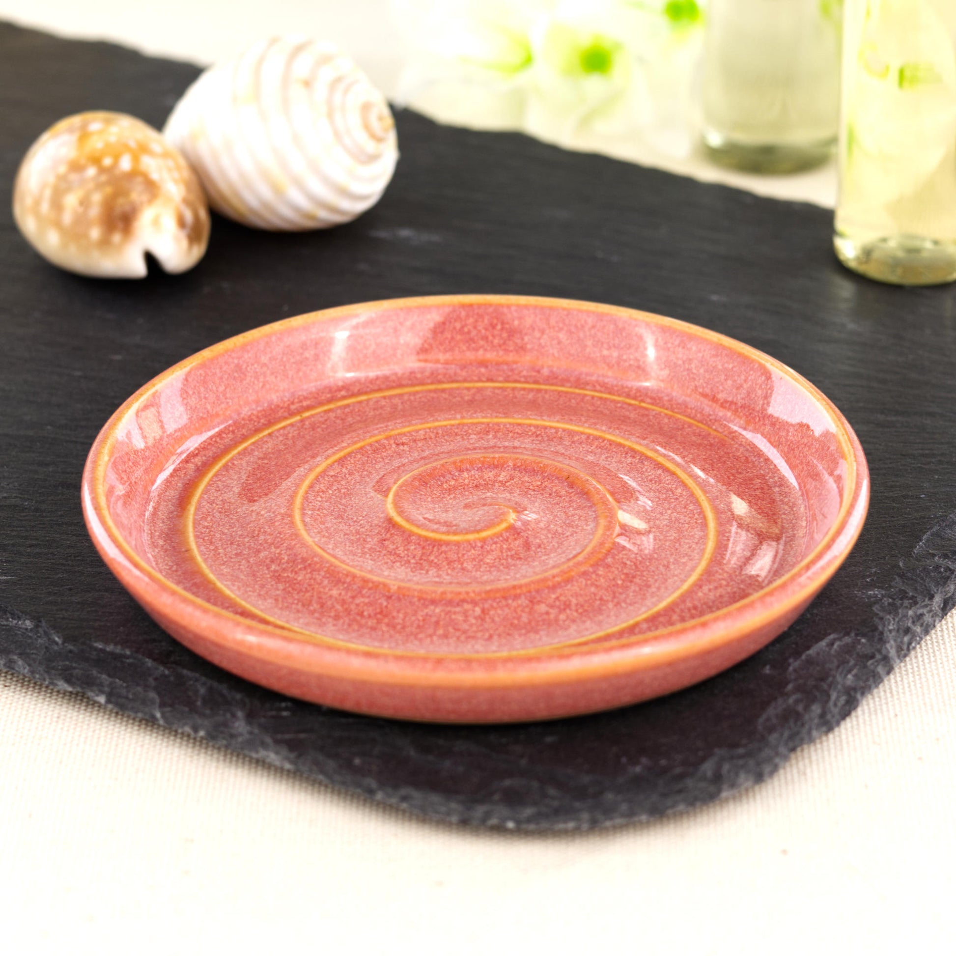Handmade coral ceramic soap dish with spiral ridges, wheel-thrown stoneware soap holder styled on slate with shells