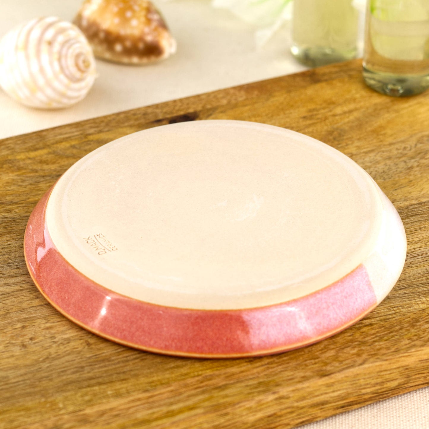 Base of coral and white soap dish with artisan makers mark, smooth burnished underside from small Sussex pottery studio