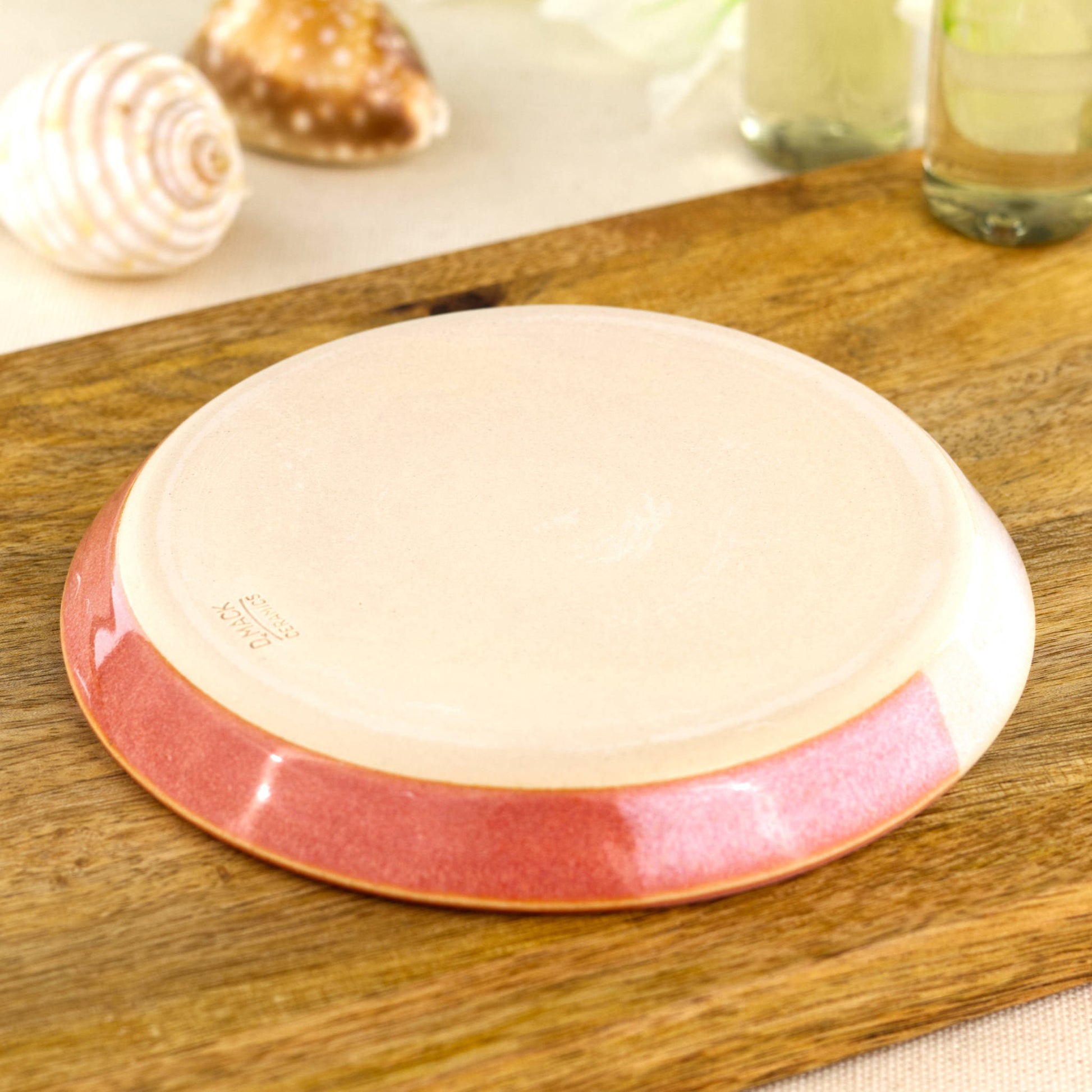 Base of coral and white soap dish with artisan makers mark, smooth burnished underside from small Sussex pottery studio
