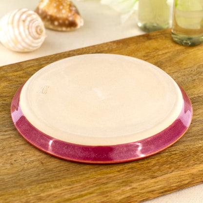 Base of handmade crimson pottery soap dish showing smooth burnished underside, wheel-thrown ceramic bathroom accessory