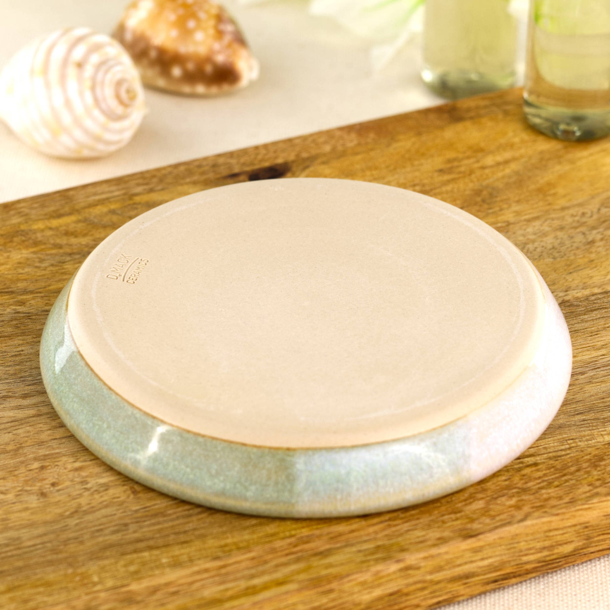 Base of pale green and white soap dish with artisan makers mark, smooth burnished underside from small Sussex pottery studio