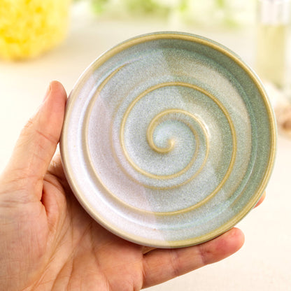 Pale green and white ceramic soap holder in hand, wheel-thrown handmade soap tray with banded double dipped glaze finish