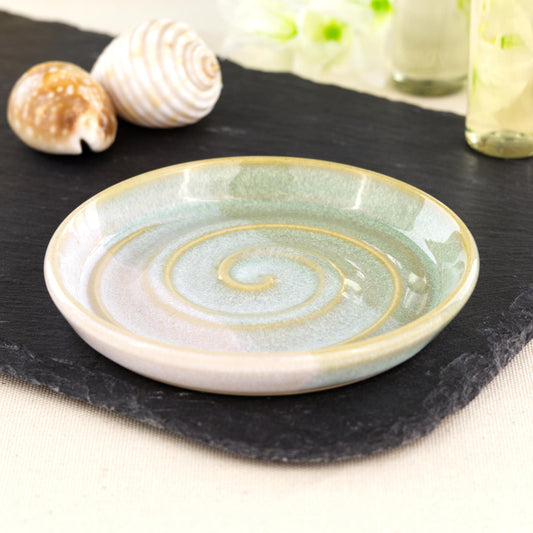 Handmade pale green and white soap dish on slate board, double dipped ceramic soap saver with spiral ridges and glossy layered glaze