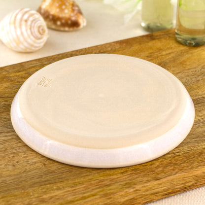 Base of handmade white pottery soap dish showing smooth burnished underside, wheel-thrown ceramic bathroom accessory