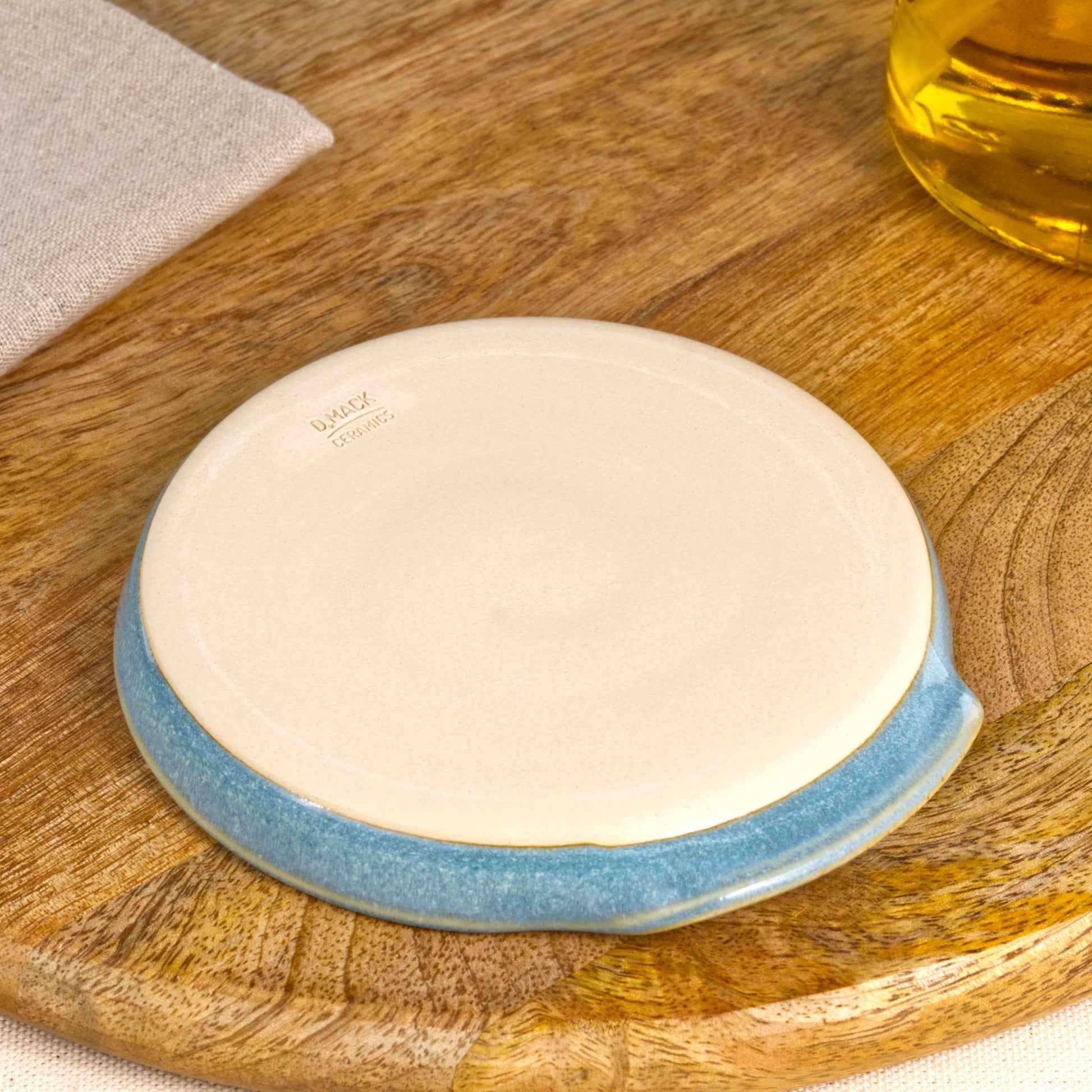 Base of handmade Coastal Blue spoon rest with makers mark, burnished smooth underside to help reduce scratches, Sussex studio pottery