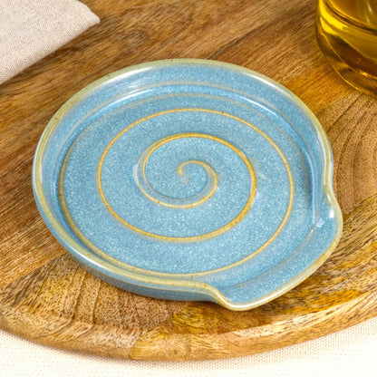 Close up of Coastal Blue pottery spoon rest with glossy speckled Sea Smoothed Pebble glaze, handmade ceramic utensil rest