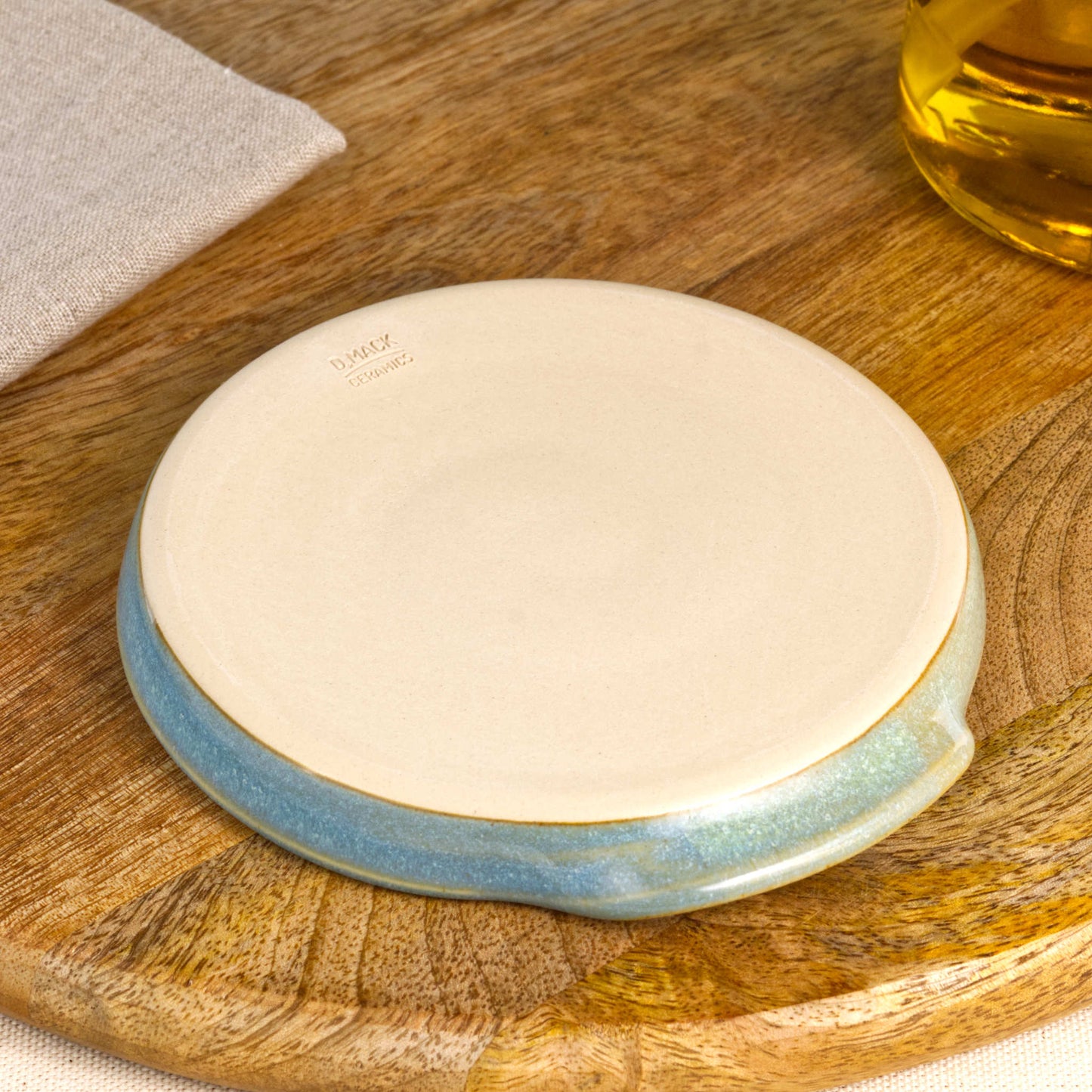 Base of handmade Coastal Blue and Pale Green spoon rest with makers mark, burnished smooth underside to help reduce scratches, Sussex pottery studio ceramic gift