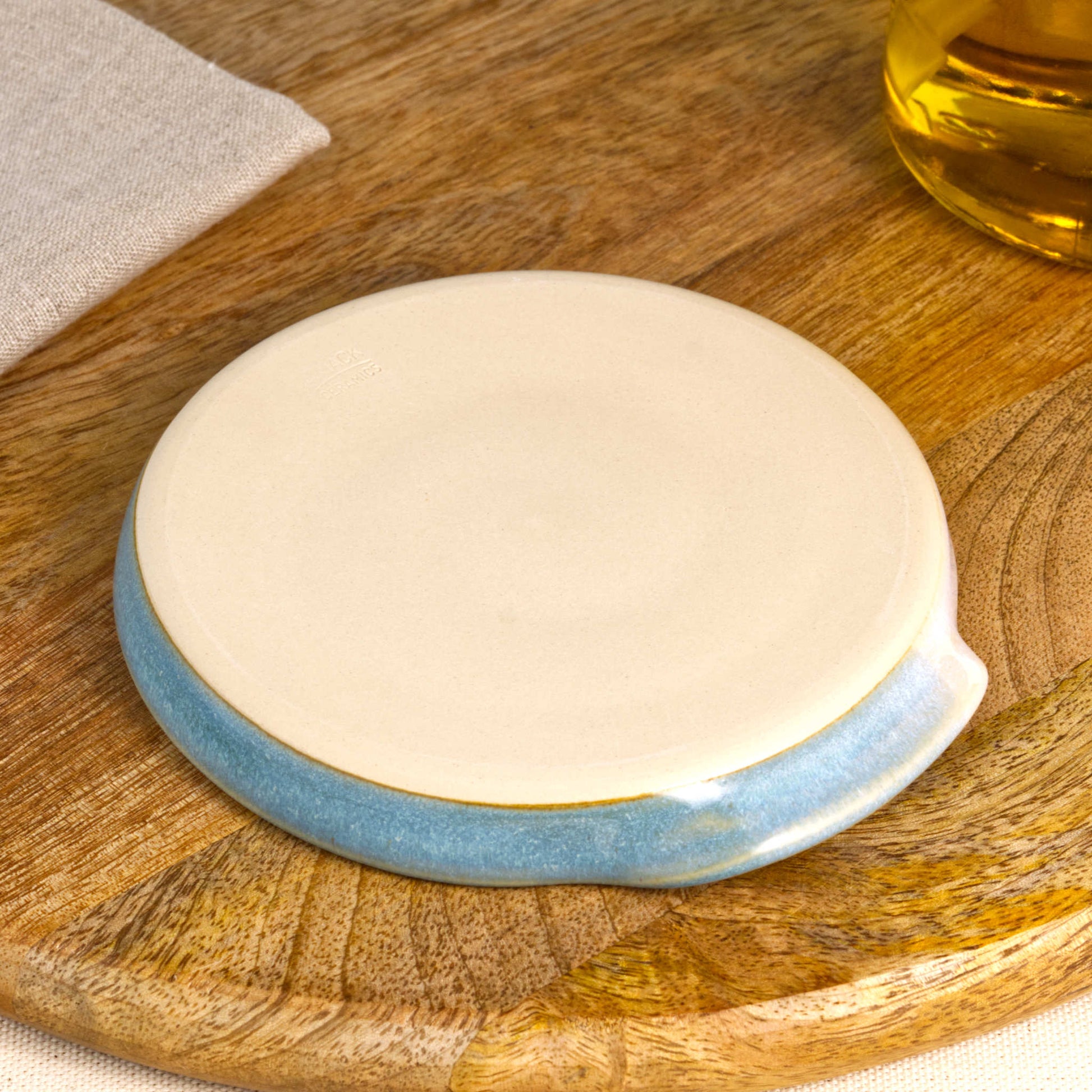 Underside of Coastal Blue and White spoon rest with makers mark, burnished smooth base from Sussex artisan pottery studio