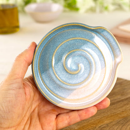 Coastal Blue and White pottery spoon rest shown in hand, compact handmade utensil holder for cooker side use
