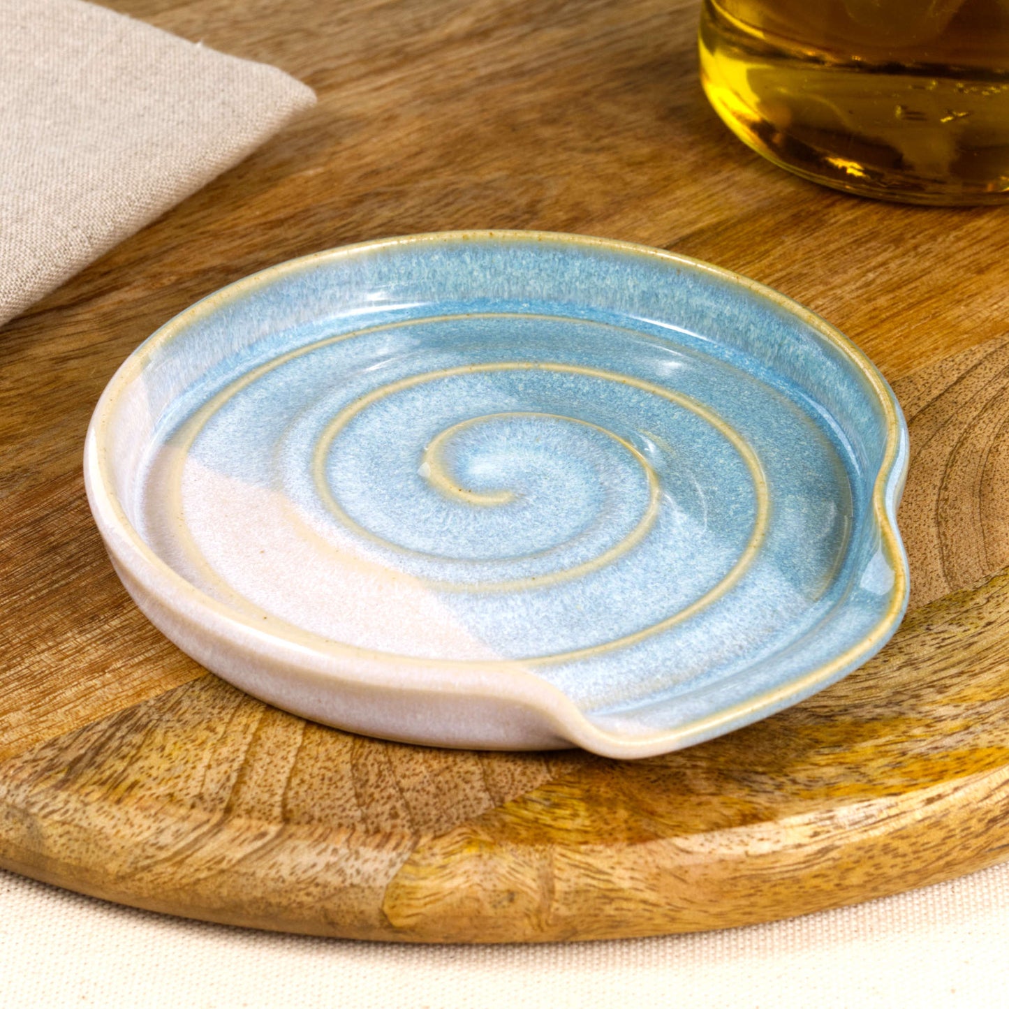 Handmade ceramic spoon rest in Coastal Blue and White, wheel-thrown kitchen spoon holder with spiral pattern and glossy speckled glaze