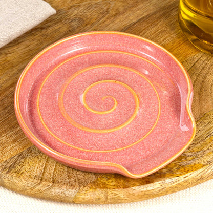 Close up of Coral pottery spoon rest with glossy speckled Sea Smoothed Pebble glaze, handmade ceramic utensil rest