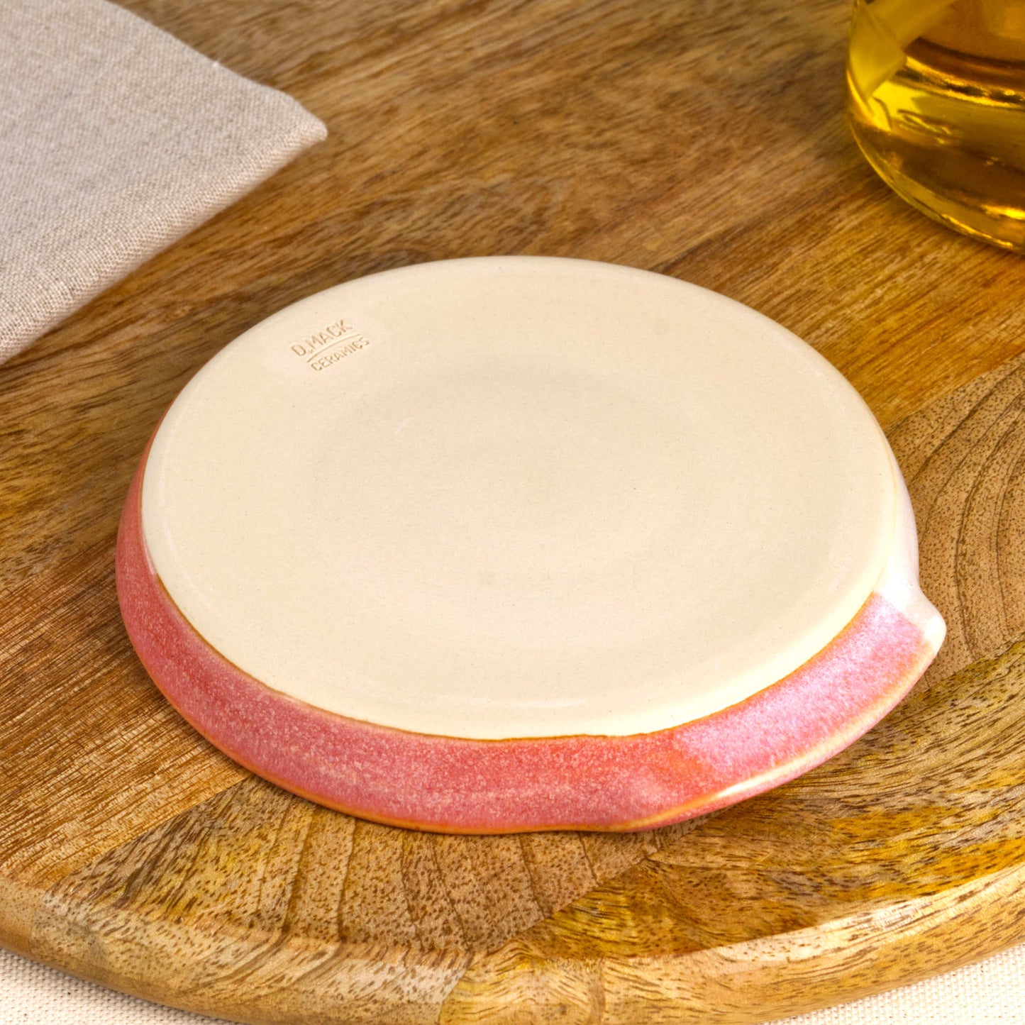Underside of Coral and White spoon rest with makers mark, burnished smooth base from Sussex artisan pottery studio