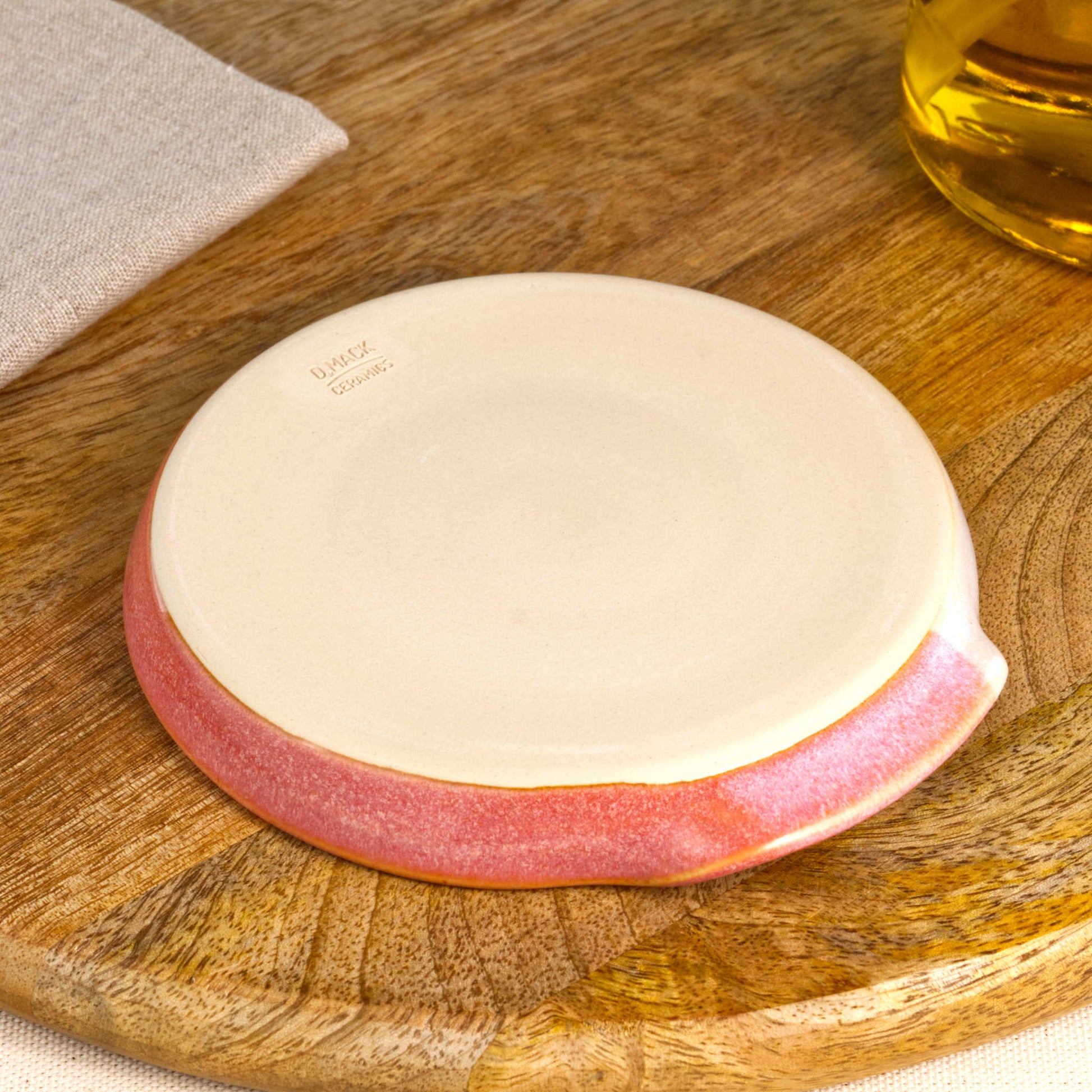Underside of Coral and White spoon rest with makers mark, burnished smooth base from Sussex artisan pottery studio