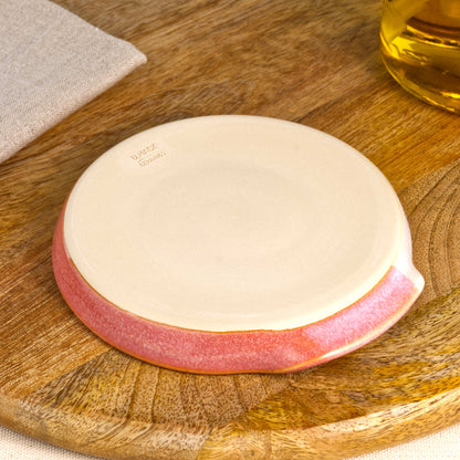 Underside of Coral and White spoon rest with makers mark, burnished smooth base from Sussex artisan pottery studio