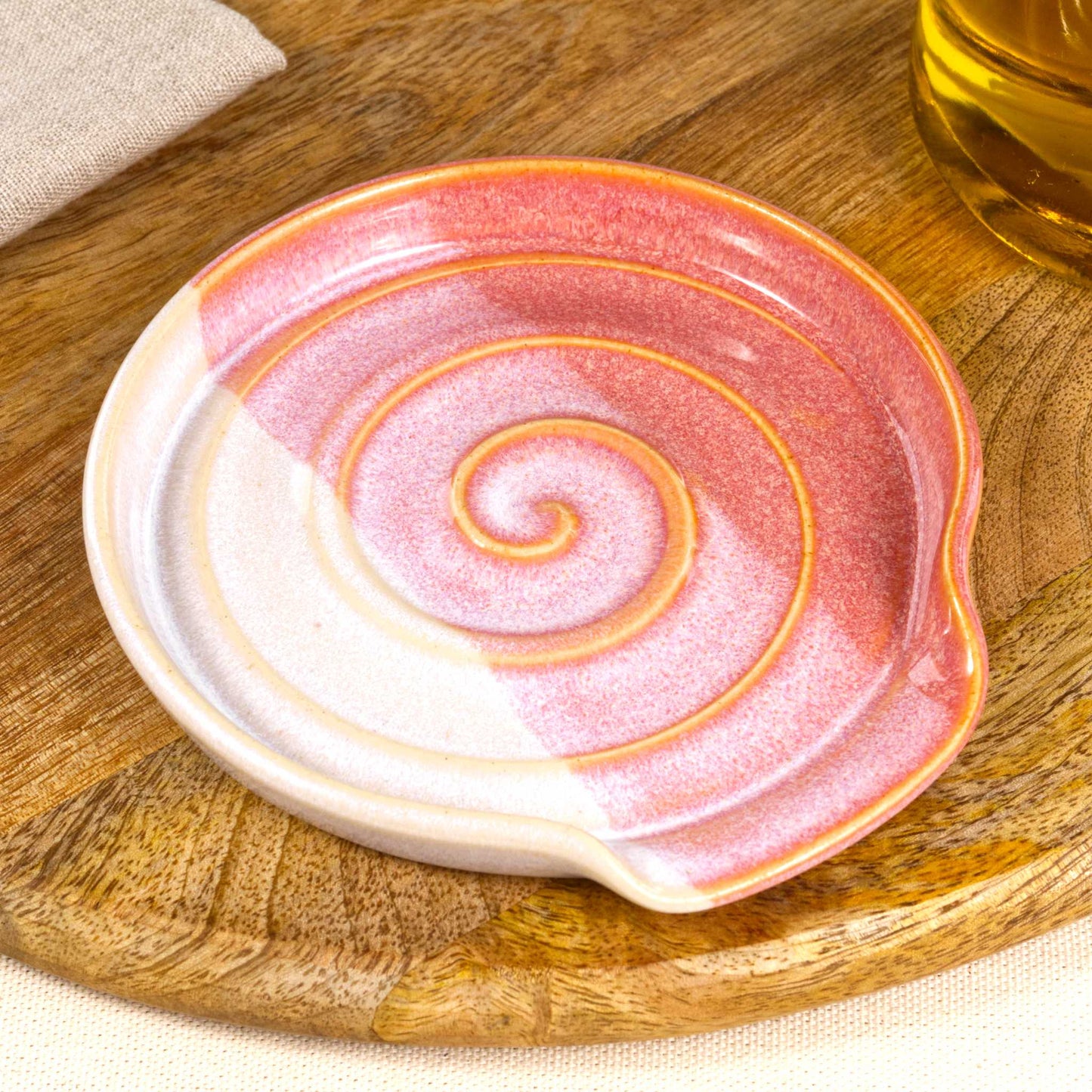 Close detail of Coral and White spoon rest, softly blended two tone glaze with spiral ridges and Sea Smoothed Pebble finish
