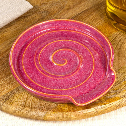 Close up of Crimson pottery spoon rest with rich glossy speckled glaze, handmade ceramic spoon stand for countertop use