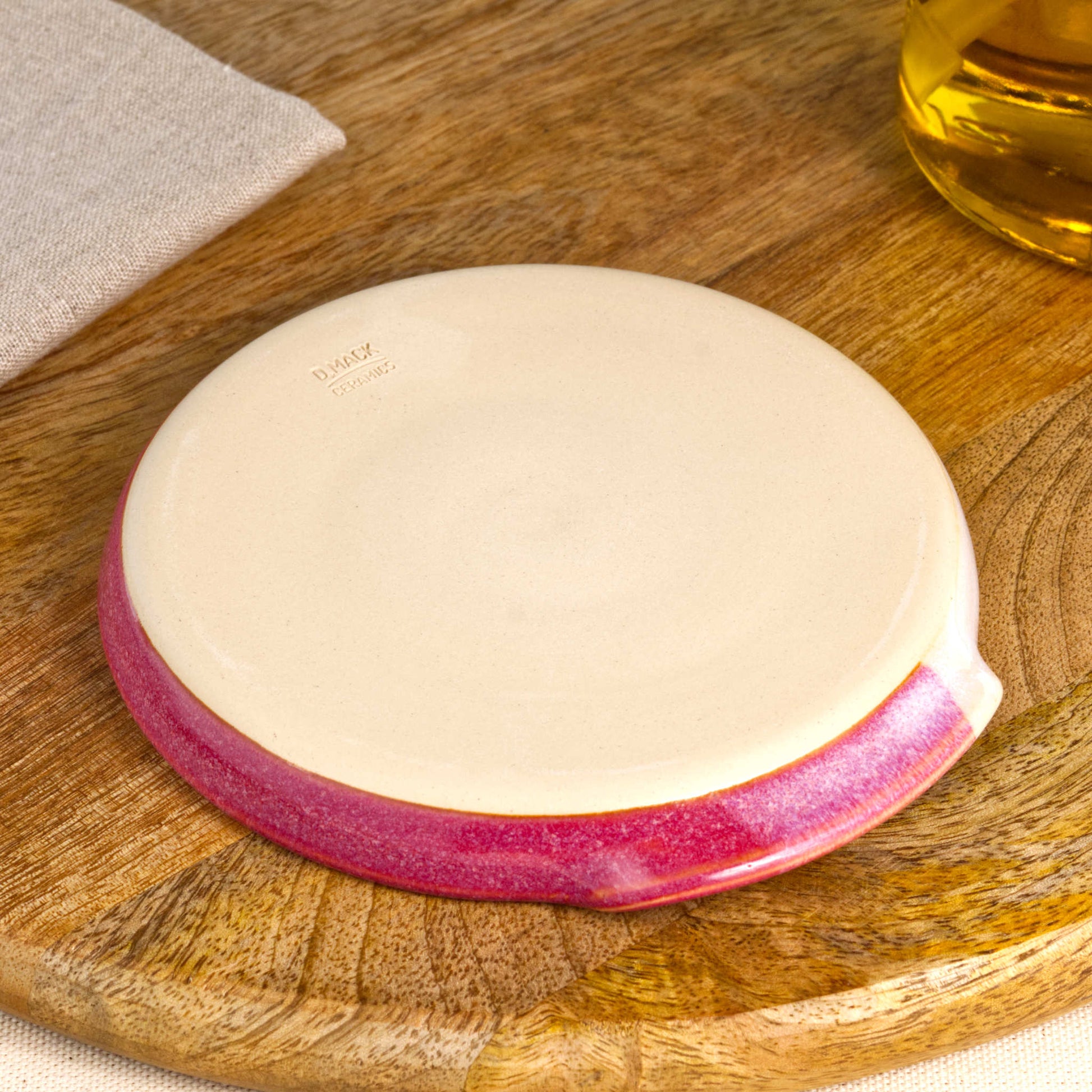 Base of handmade crimson and white spoon rest with makers mark, burnished smooth underside to help reduce scratches, Sussex pottery studio ceramic gift