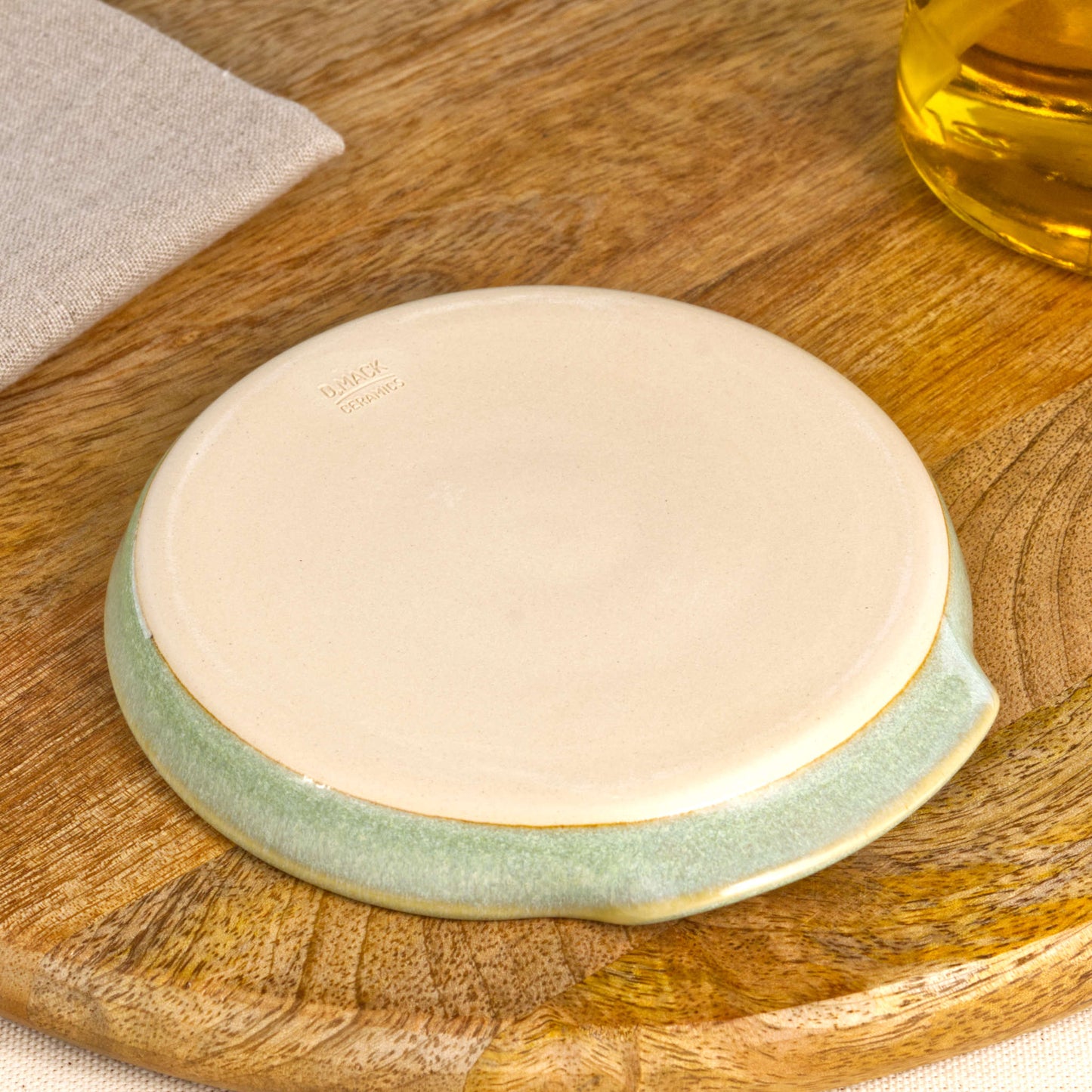 Base of handmade Pale Green spoon rest with makers mark, burnished smooth underside to help reduce scratches, Sussex studio pottery