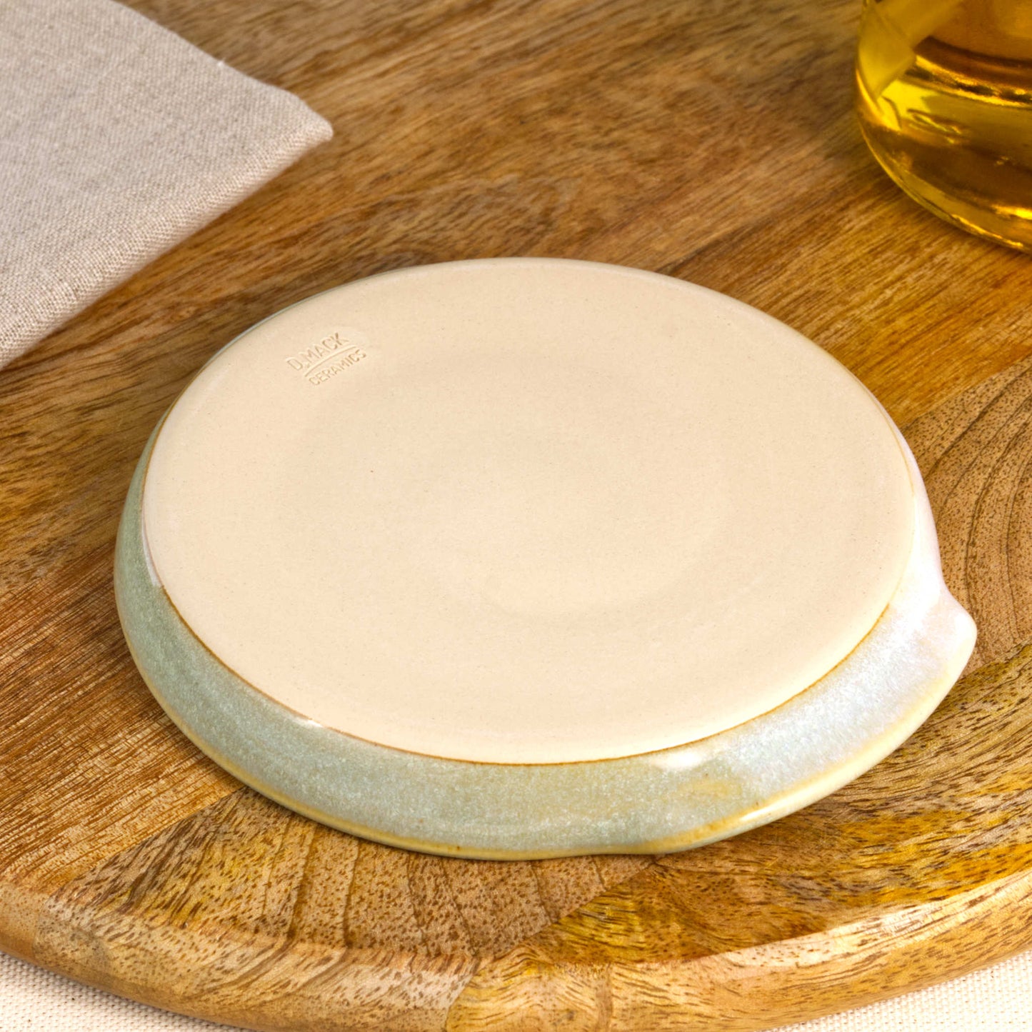 Underside of Pale Green and White spoon rest with makers mark, burnished smooth base from Sussex artisan pottery studio