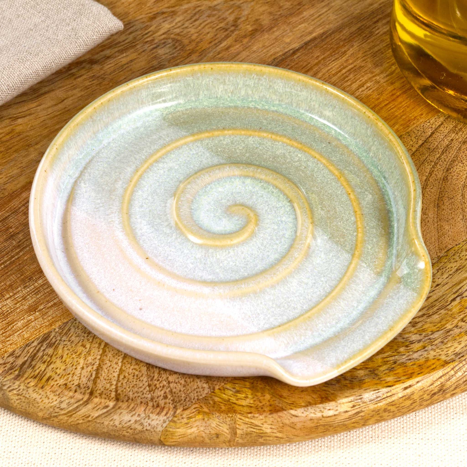 Close detail of Pale Green and White spoon rest, softly blended two tone glaze with spiral ridges and Sea Smoothed Pebble finish