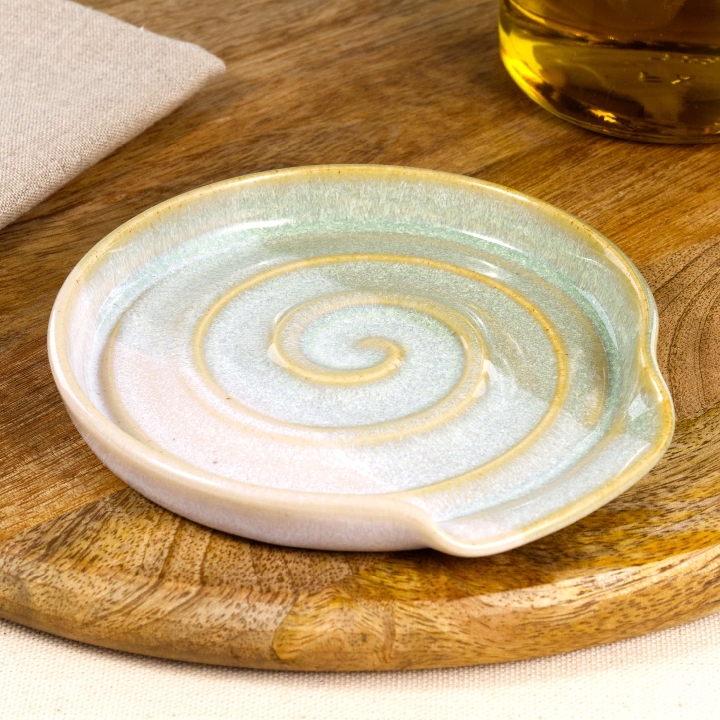 Handmade ceramic spoon rest in Pale Green and White, wheel-thrown utensil holder with spiral grooves and glossy speckled glaze