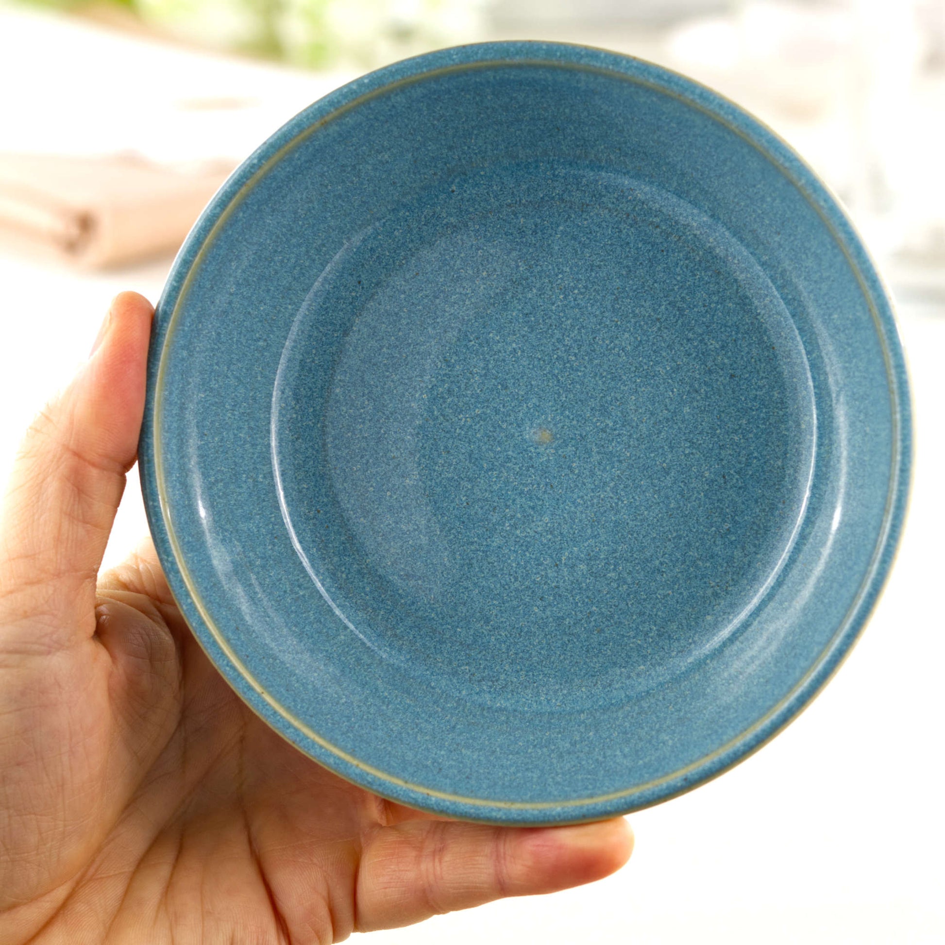 Handmade Coastal Blue ceramic tapas bowl held in the hand, a British studio pottery dish sized for olives, dips, mezze and side dishes