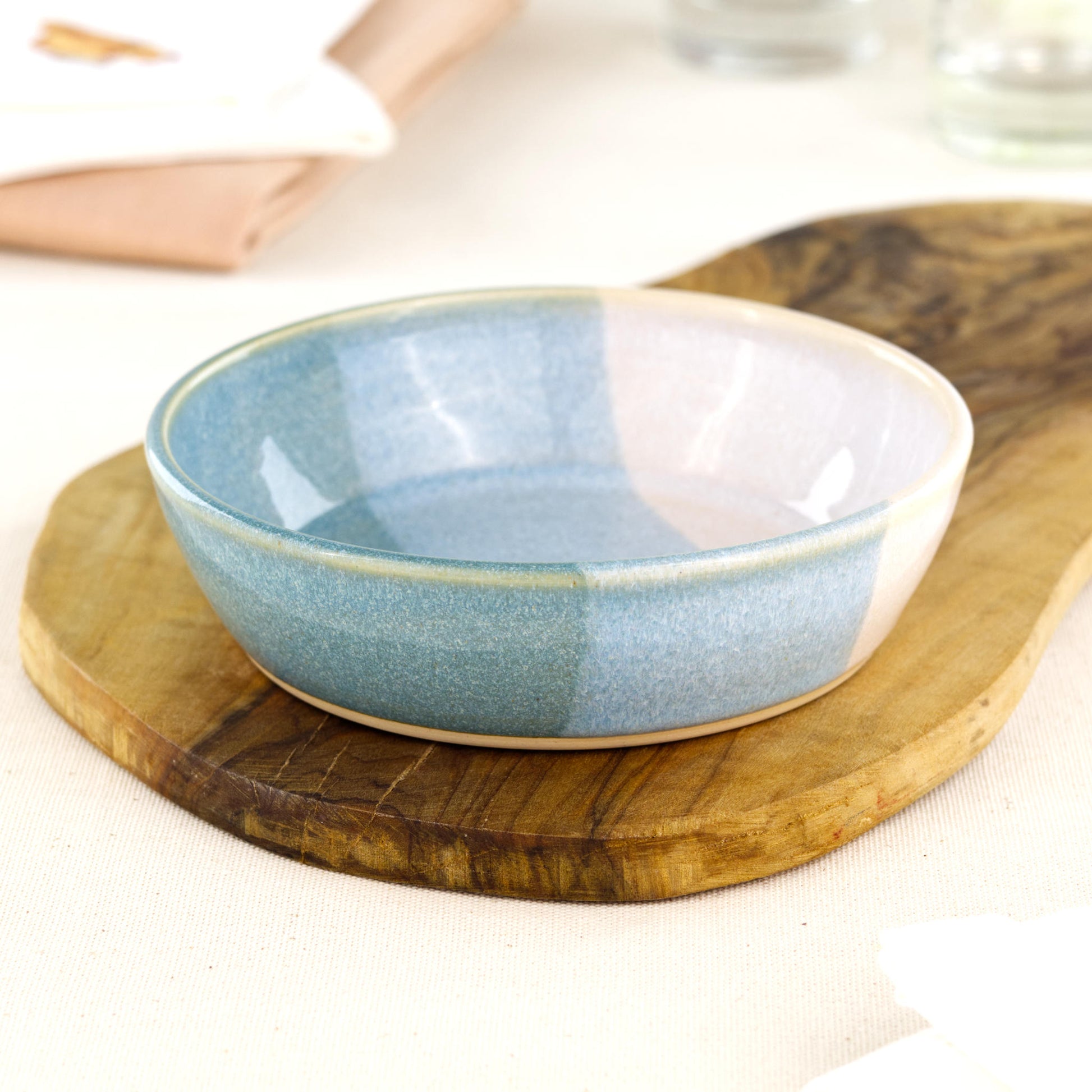 Wheel-thrown Coastal Blue & White tapas bowl on an olive wood board, a British studio pottery dish for antipasti, mezze, olives and casual entertaining