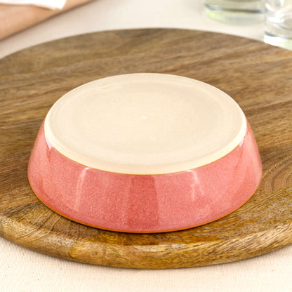 Base of a wheel-thrown Coral tapas bowl, showing the smooth burnished foot and makers mark, handmade in a small Sussex pottery studio
