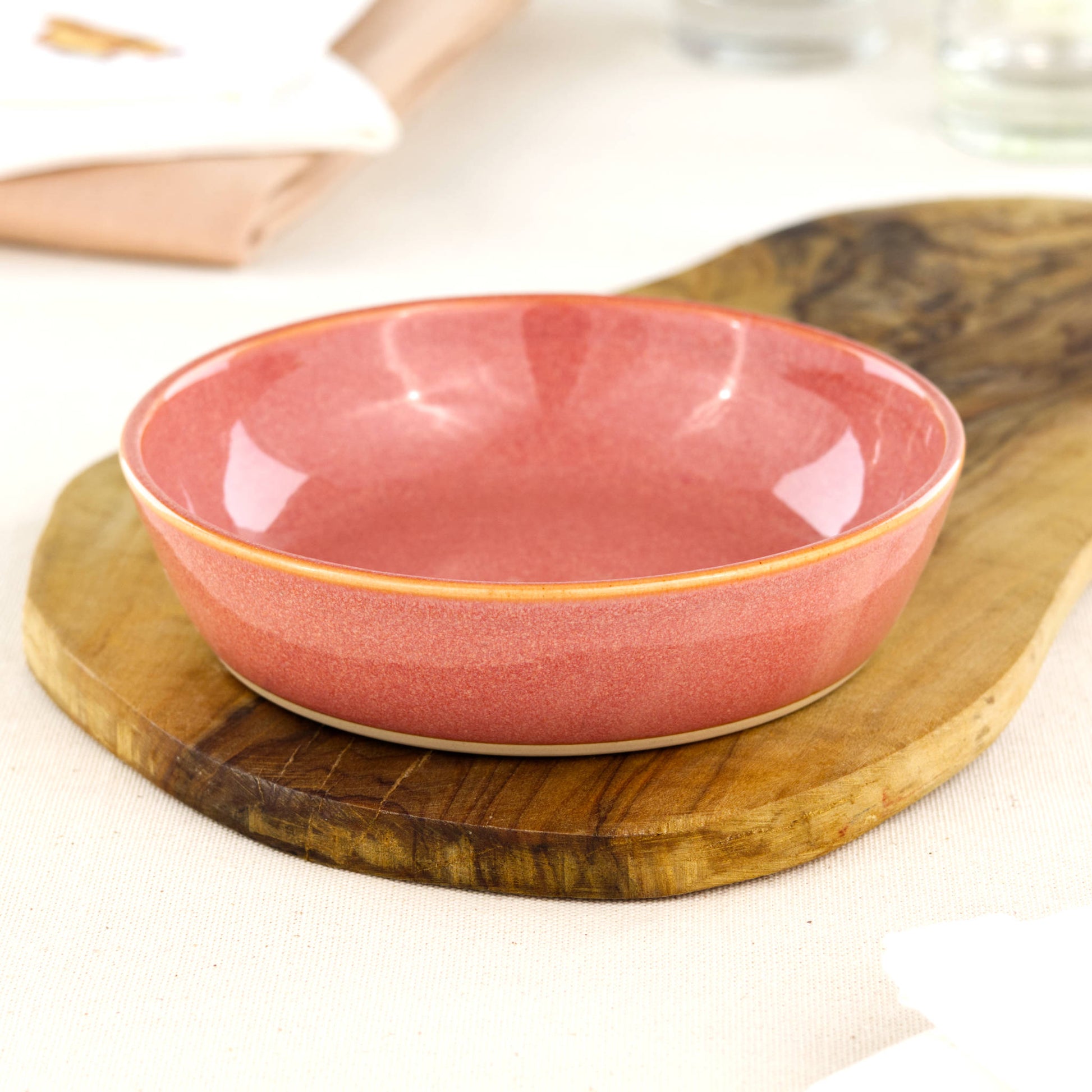 Wheel-thrown Coral tapas bowl on an olive wood board, handcrafted in Sussex for tapas, picky bits, BBQ snacks and artisan tableware